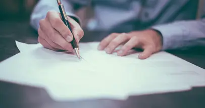 Person at Desk Filling out Application Forms
